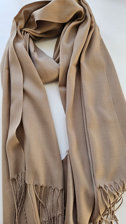 Light dusty brown scarf with fringes on a white background