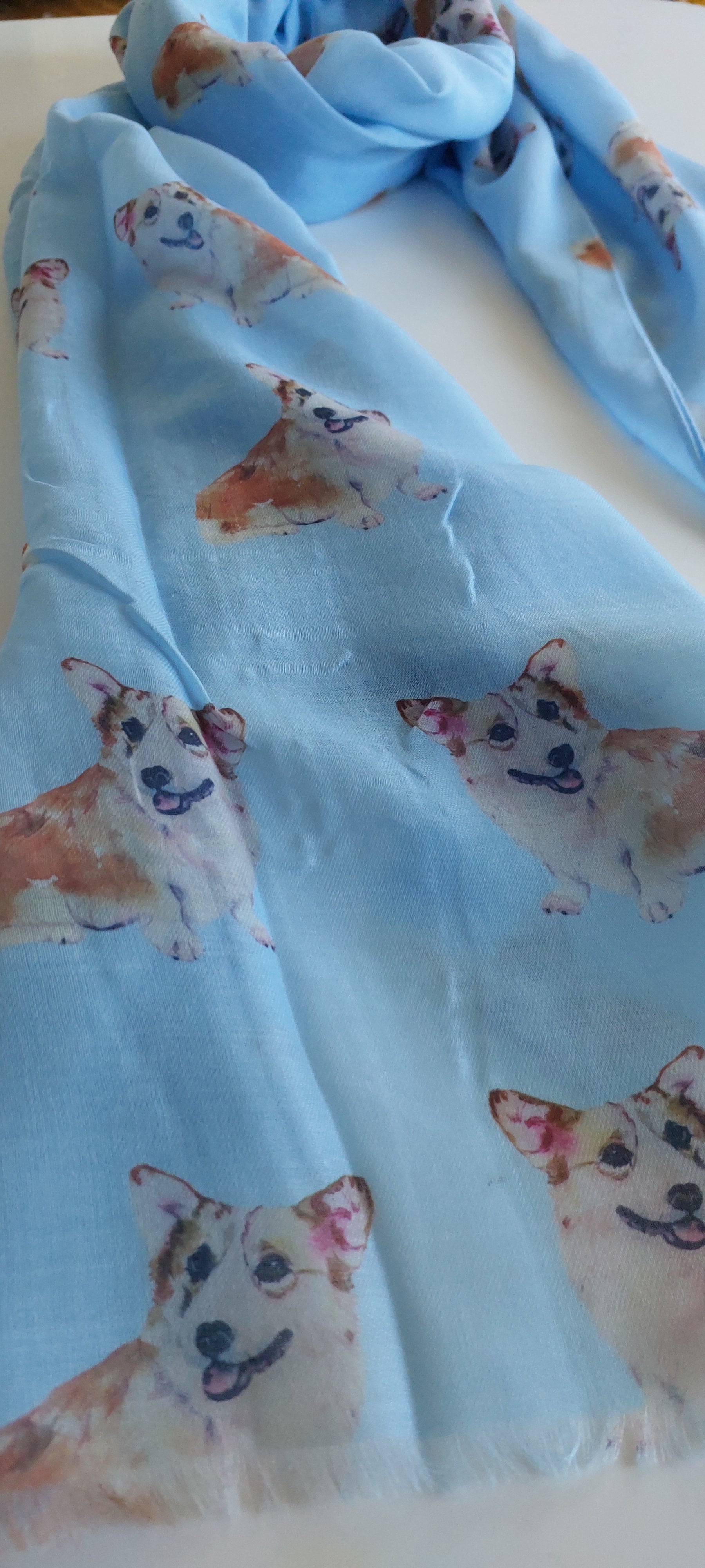 Blue scarf with corgi pattern on a white background