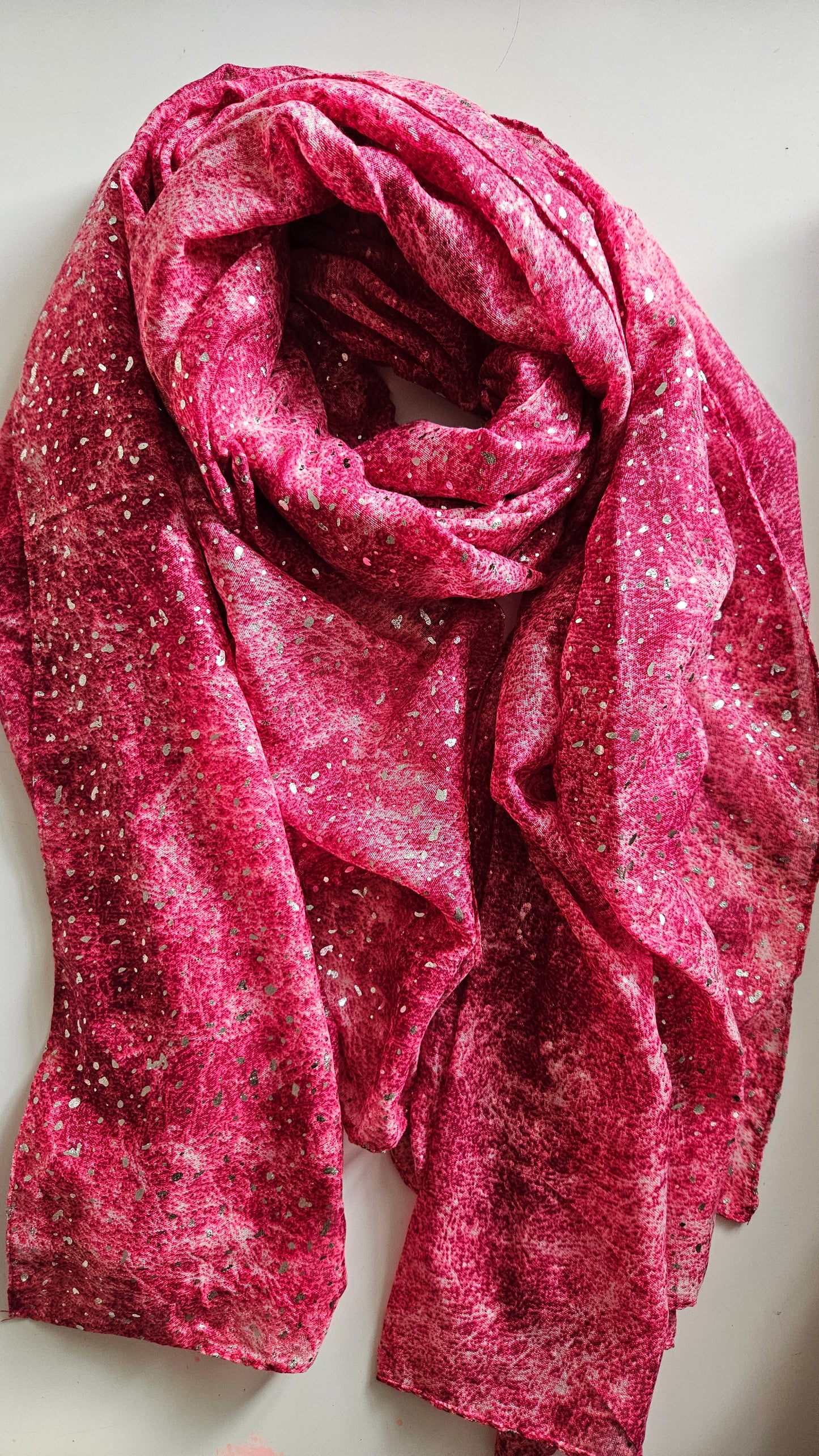 Pink scarf with glittery texture on a light background