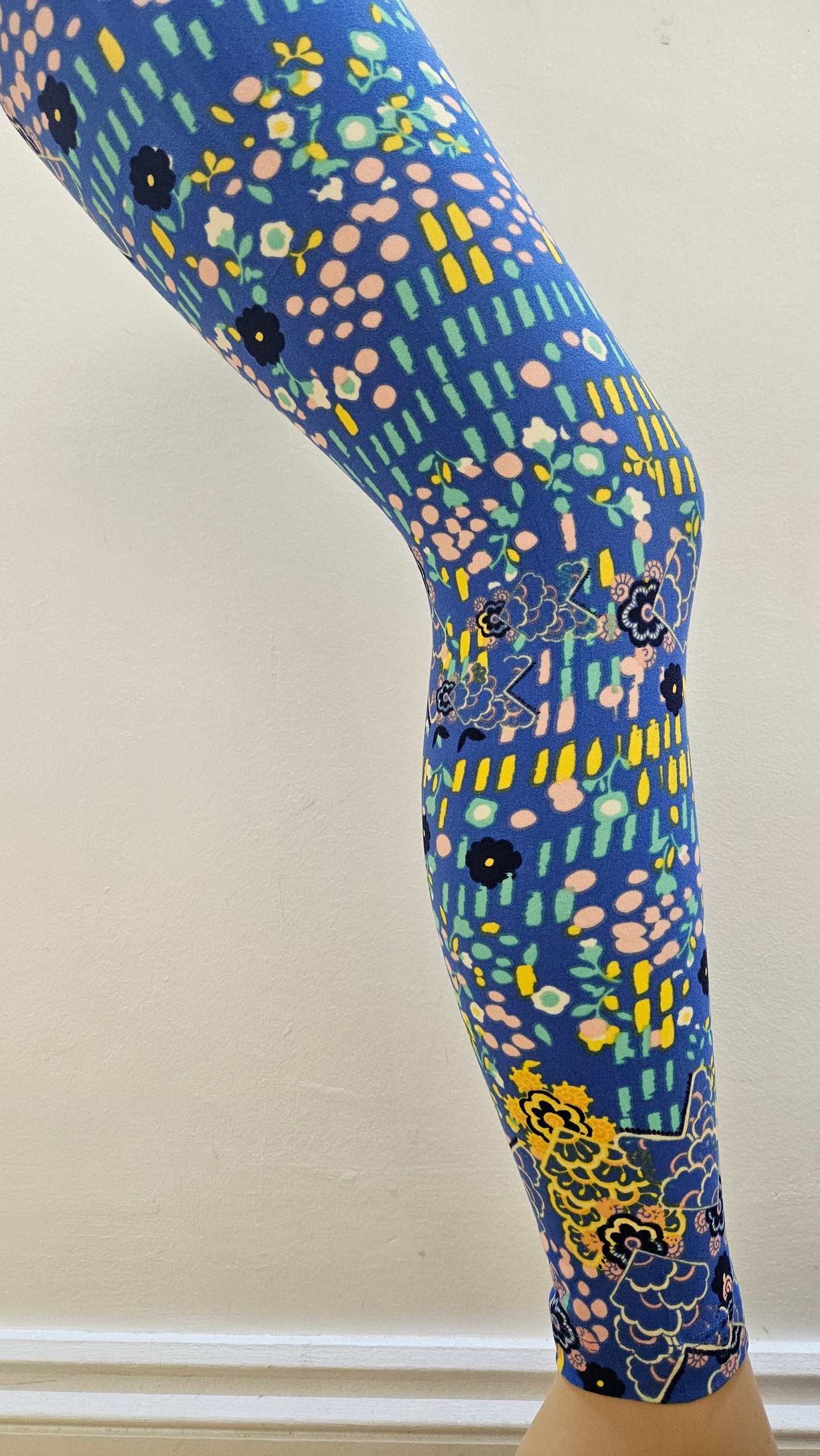 Colourful patterned leggings on a plain background