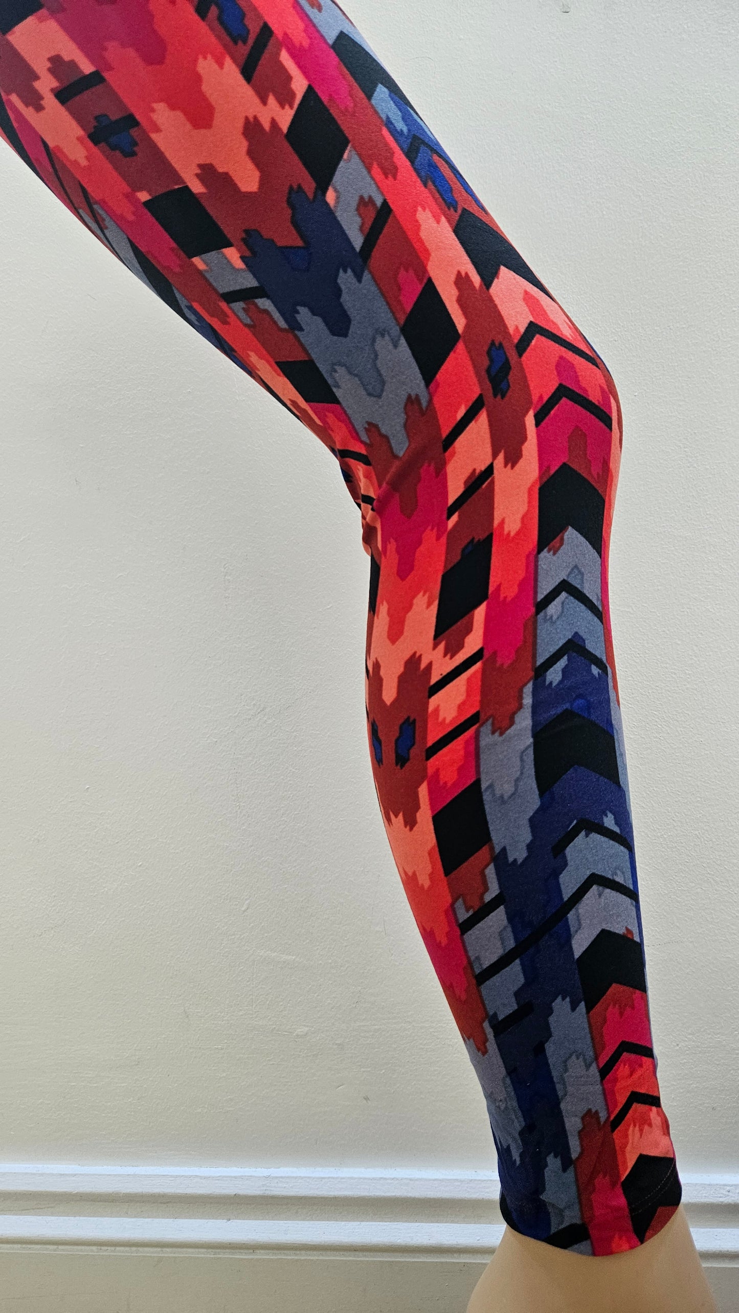 Colourful patterned leggings on a white background