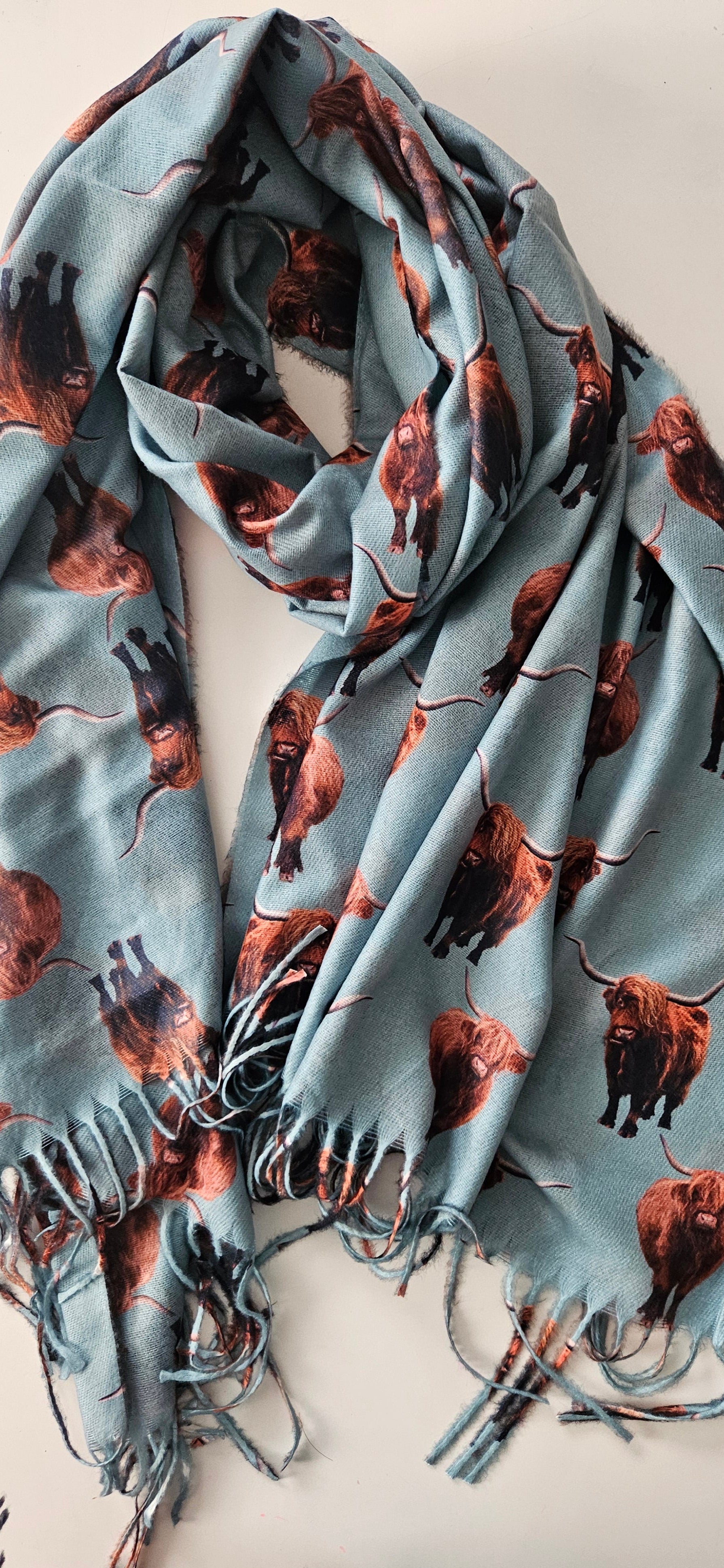 Mint Green scarf with highland cow print on a white background
