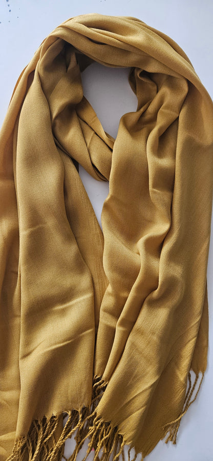 mustard coloured scarf with fringes on a white background