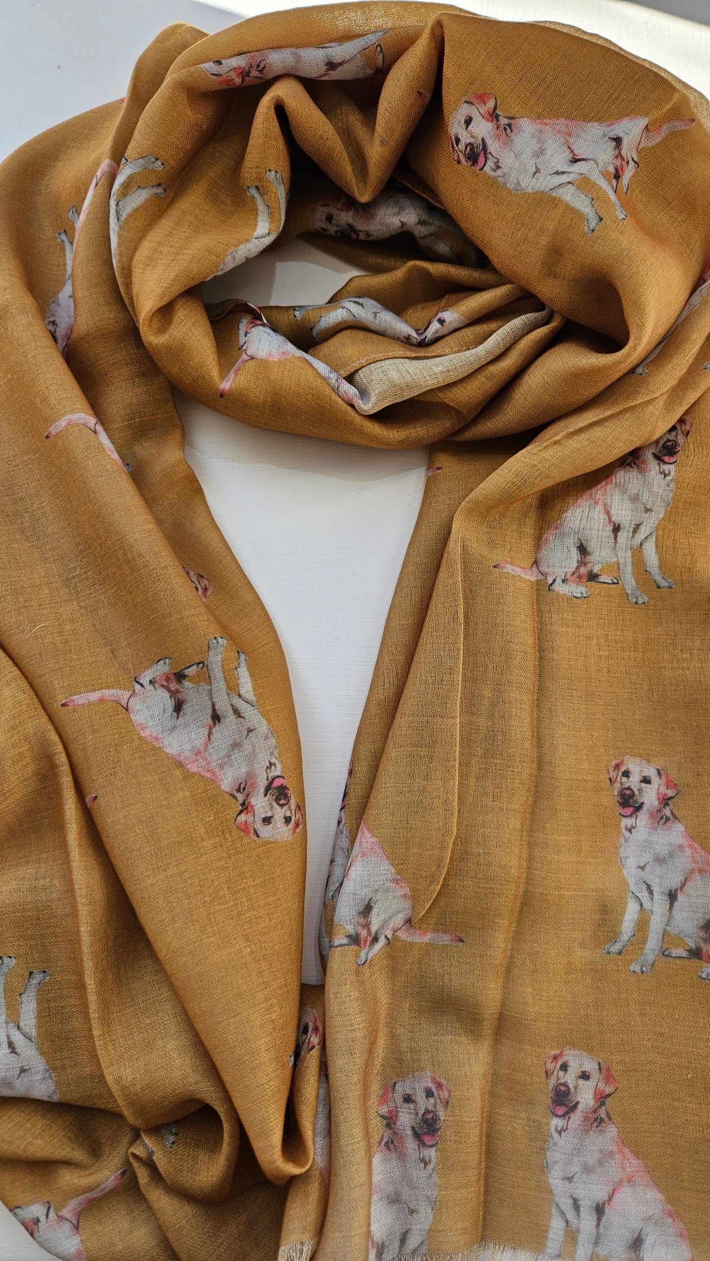 Mustard yellow scarf with golden Labrador dog print on a white background
