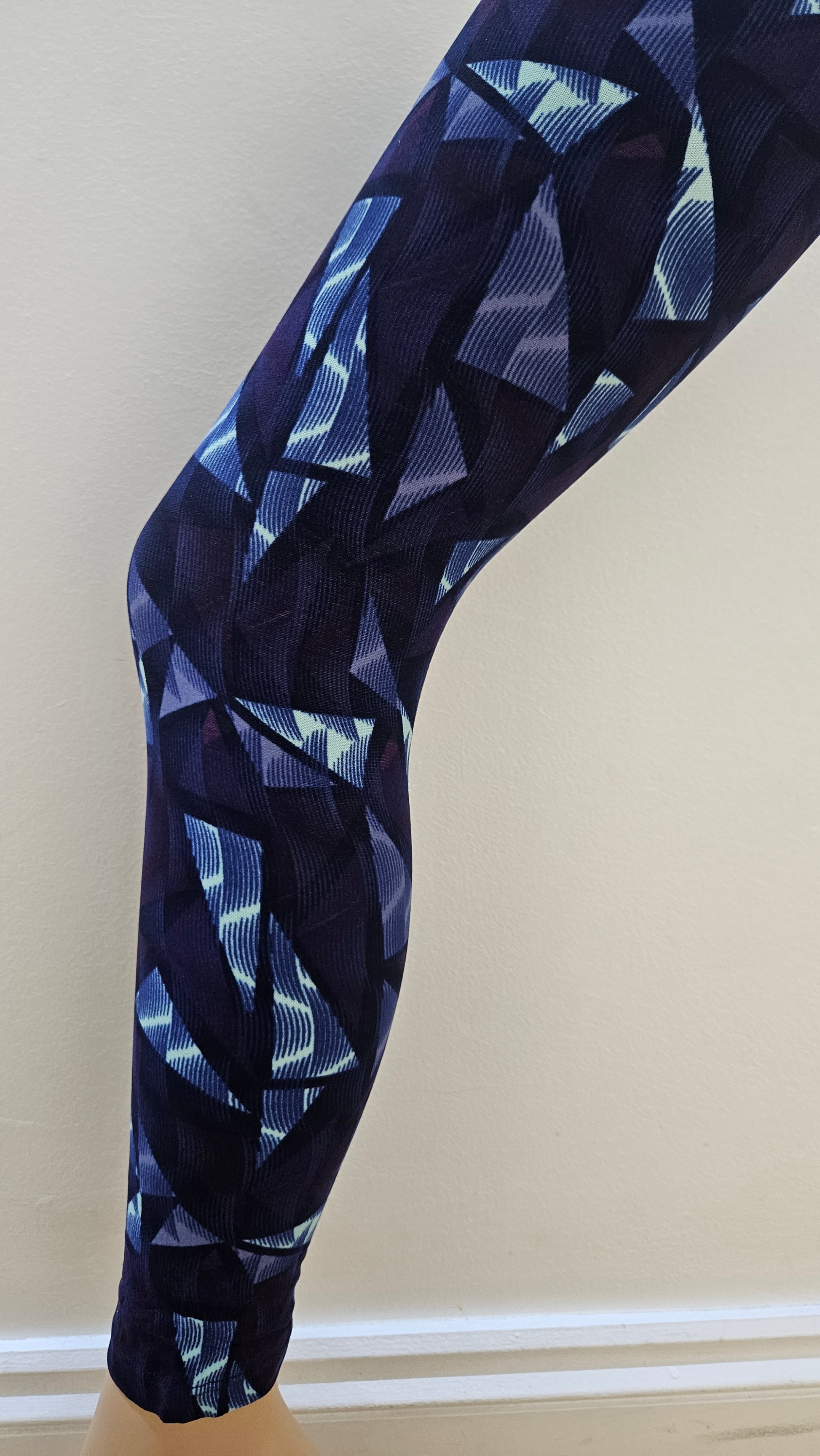 Navy blue leggings with geometric pattern on a white background