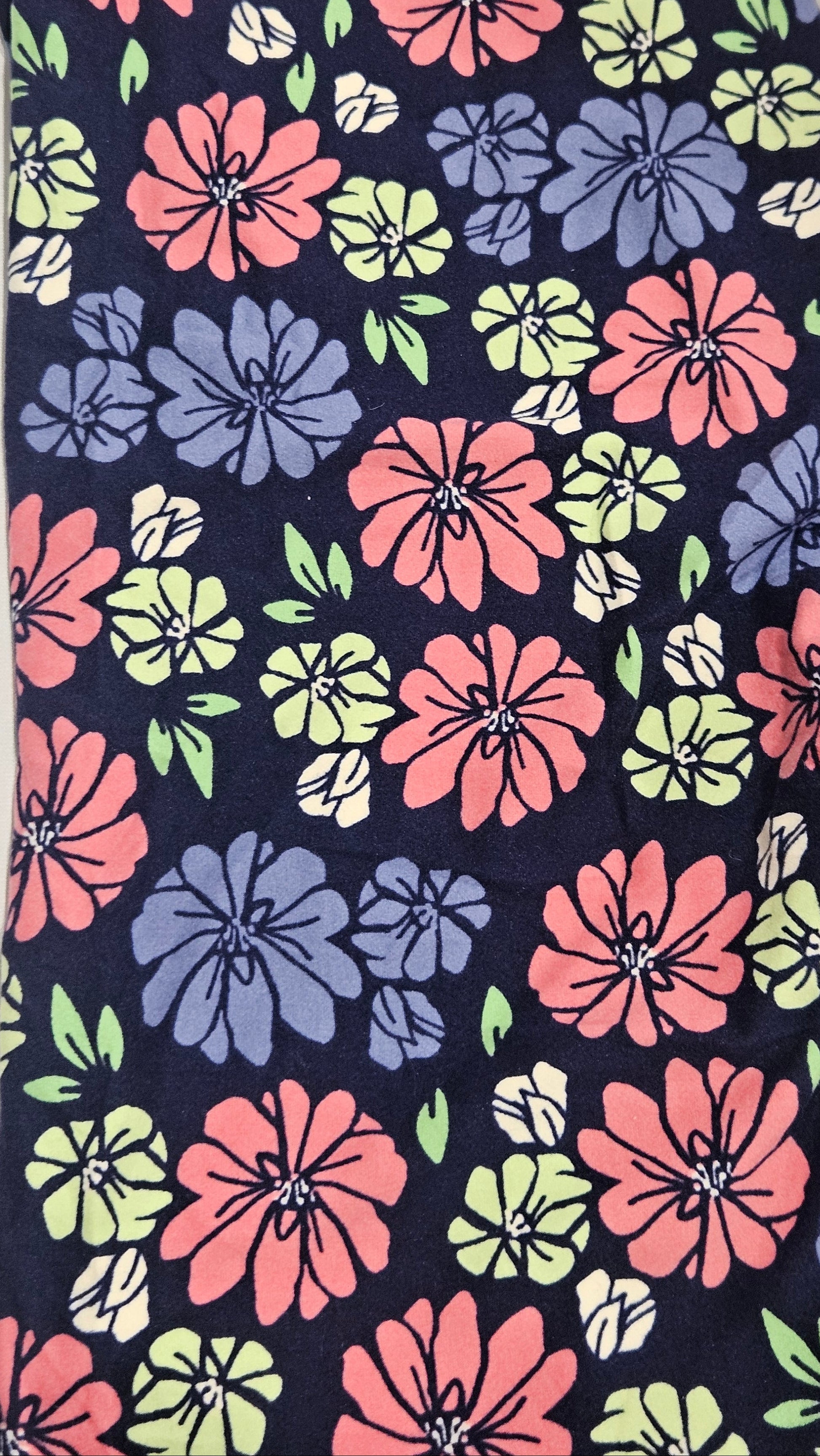 Floral patterned fabric with pink, blue, and green flowers on a dark background