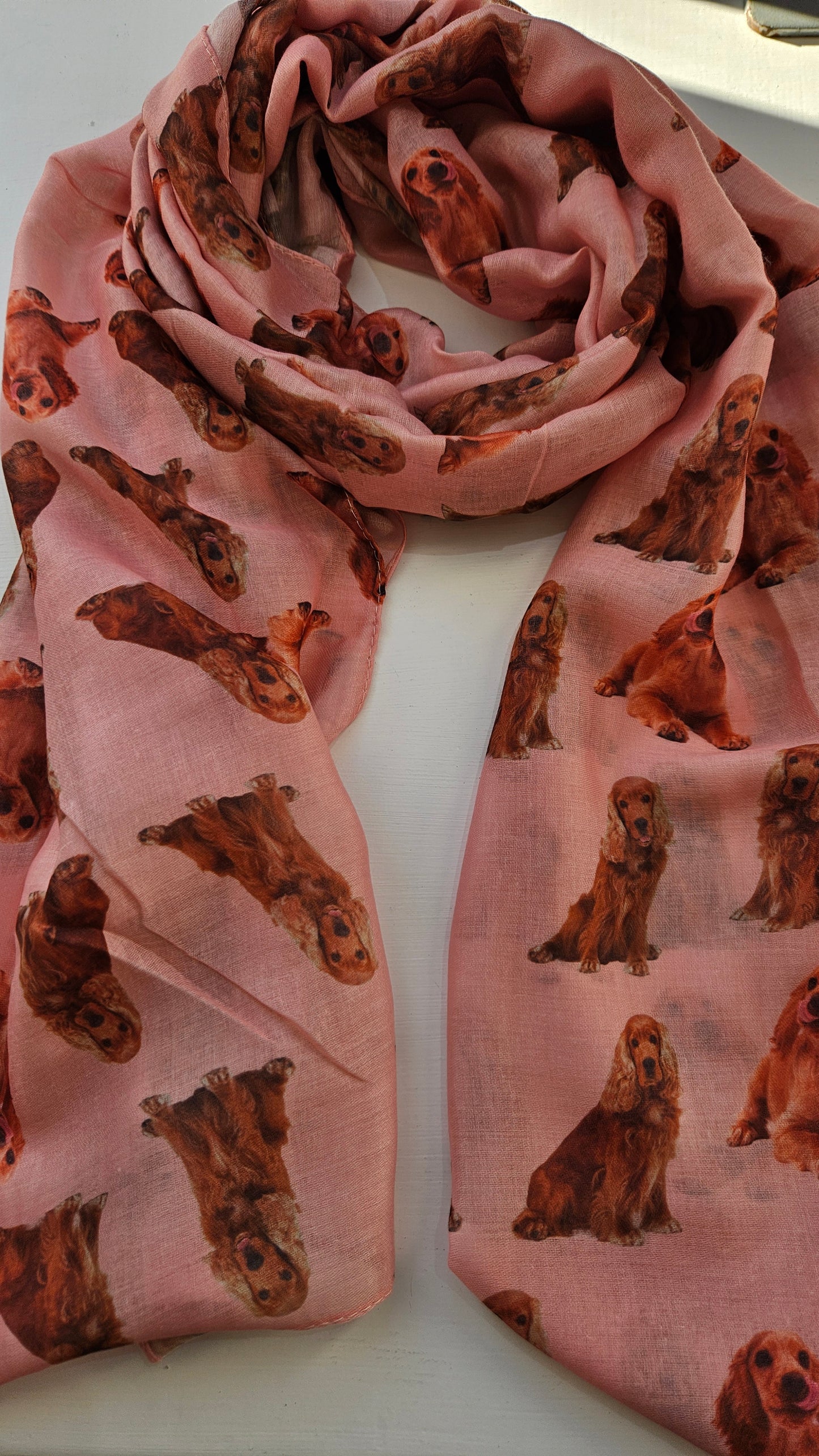 Pink scarf with tan cocker spaniel print on a white background