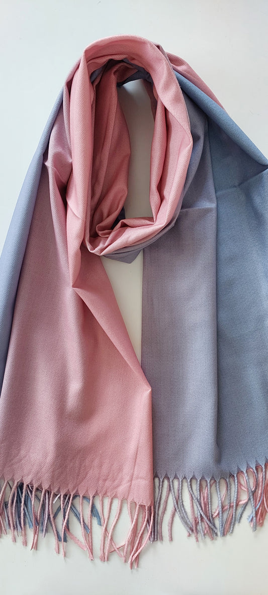 Folded fabric with pink and lilac two-toned colors on a white background