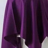 Purple scarf draped over a surface with a plain background