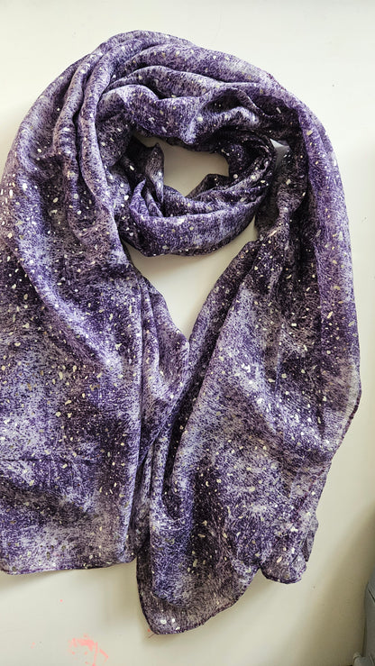 Purple textured scarf with silvery glitter dots on a light background