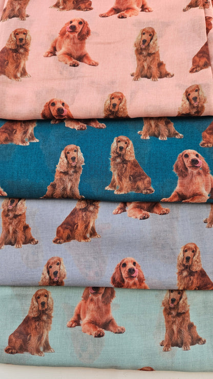 Collection of scarves with tan cocker spaniel pattern on a white background
