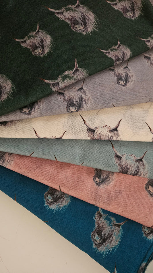 Collection of pashminas with Black and White Highland Cow pattern in various colours.