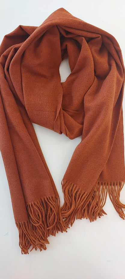 rusty brown Shimena scarf with tassels on each end laid flat on a white background