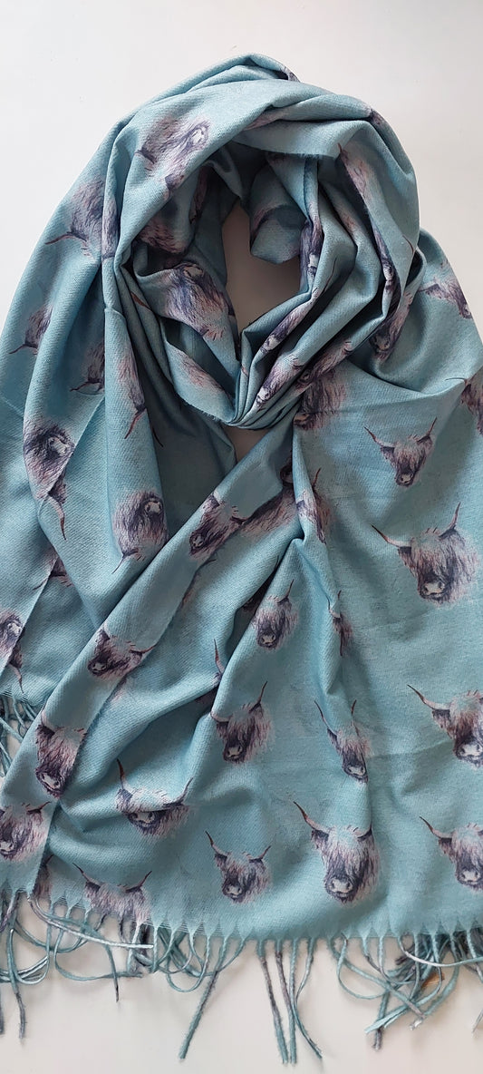 Sage pashmina scarf with black and white highland cow pattern on a white background