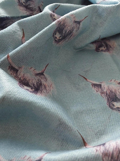 Pashmina with black and white highland cow print on a white  background