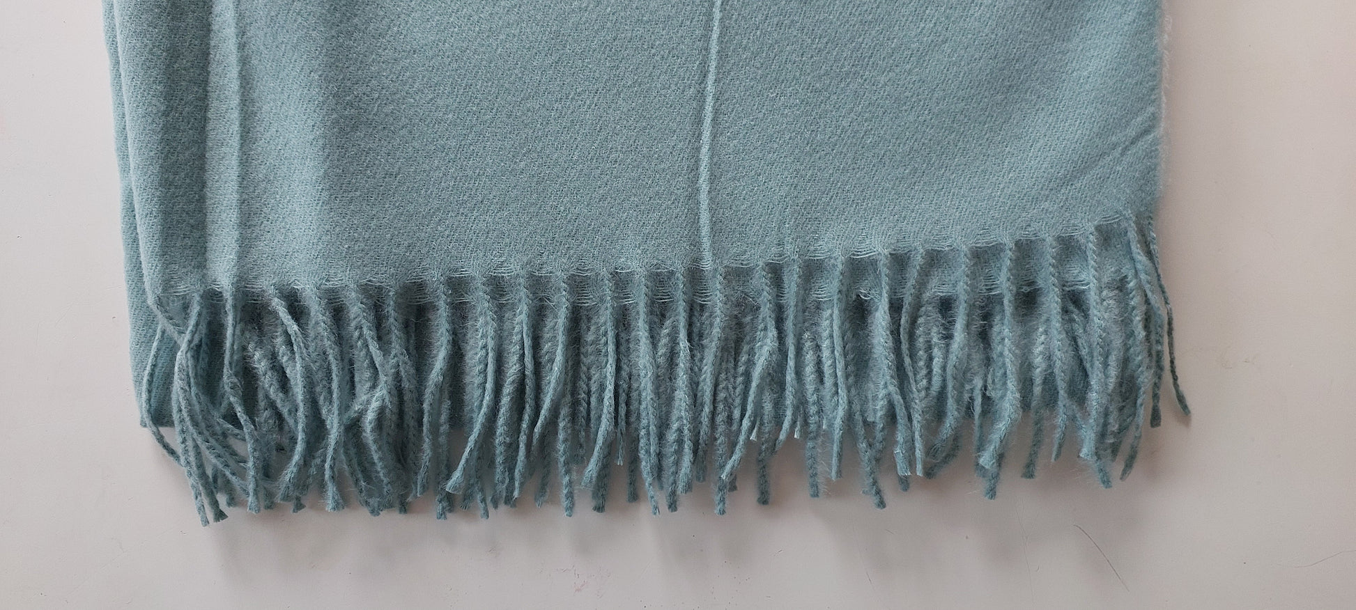Sage pashmina with fringes on a white background