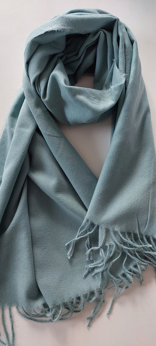 Green pashmina with tassels on a white background