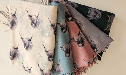 Selection of Monochromatic Highland cow pashminas on a white background 