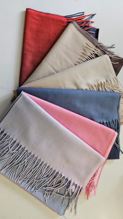 Selection of two toned pashminas on a white background 