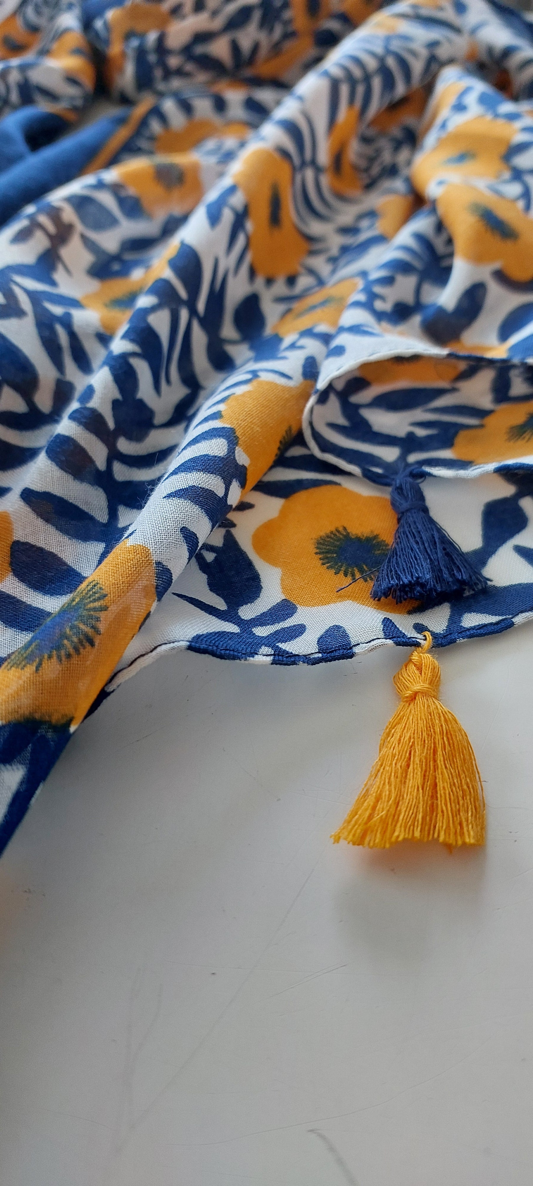 Floral-patterned Scarf with yellow tassels on a white background