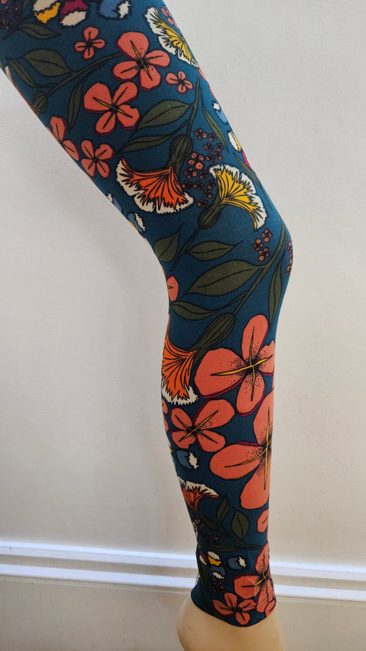 Floral-patterned leggings on a mannequin leg against a white background