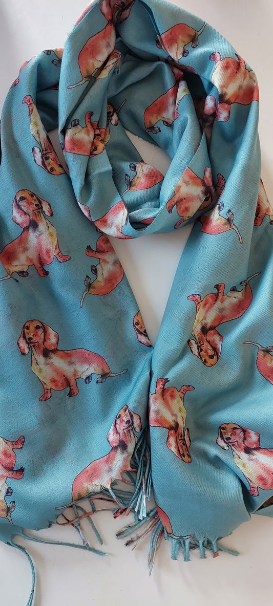 Turquoise pashmina with tan sausage dog pattern on a white background