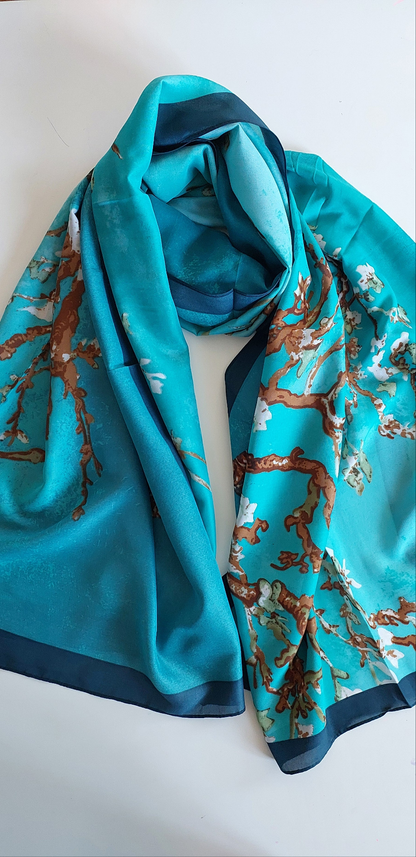 Teal silky scarf with floral pattern on a white background