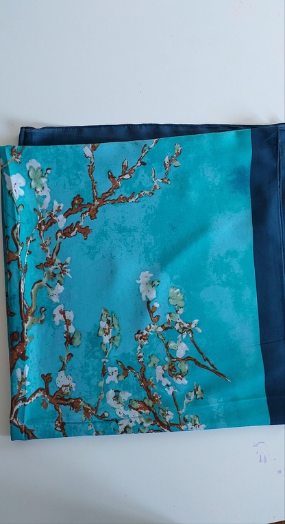 Teal Silky Scarf with Almond Blossom pattern folded on a white background