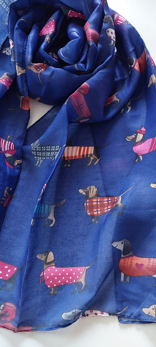 Blue scarf with cartoon sausage dog pattern on a white background